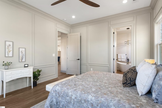 bedroom featuring ceiling fan, dark hardwood / wood-style flooring, and ensuite bath