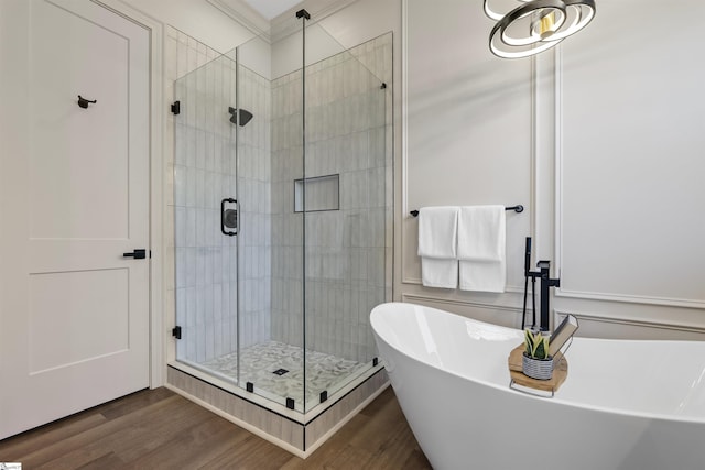 bathroom featuring hardwood / wood-style flooring and independent shower and bath