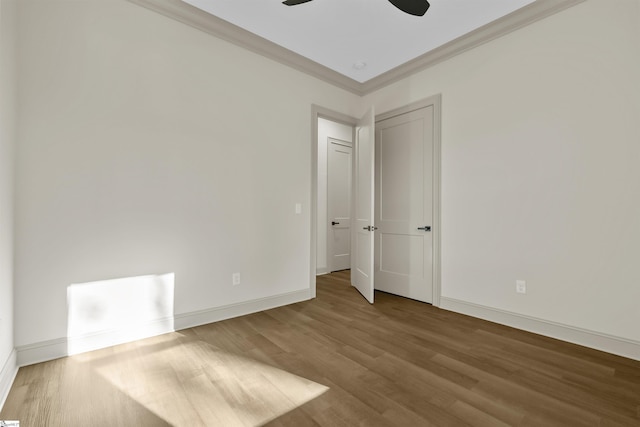 spare room featuring ceiling fan, hardwood / wood-style floors, and ornamental molding