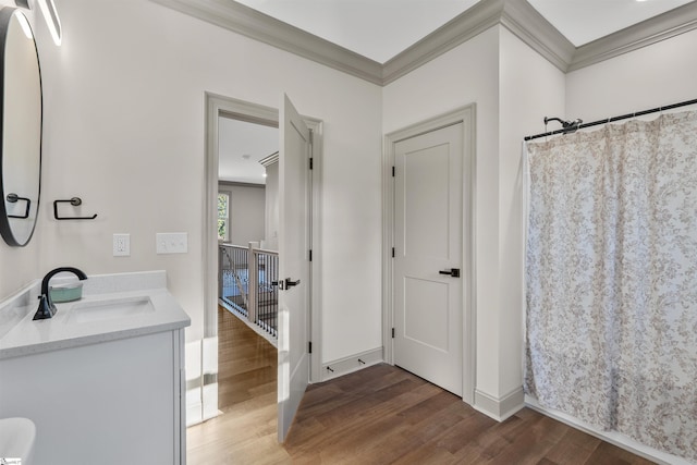 bathroom with walk in shower, vanity, crown molding, and hardwood / wood-style flooring