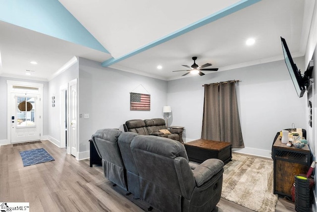 living room with vaulted ceiling, ceiling fan, ornamental molding, and light hardwood / wood-style flooring