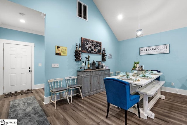 dining room with vaulted ceiling and dark hardwood / wood-style flooring