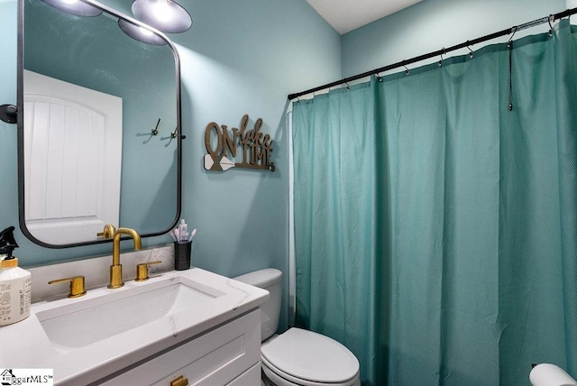 bathroom featuring toilet and vanity