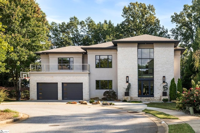 view of front of house featuring a balcony and a garage