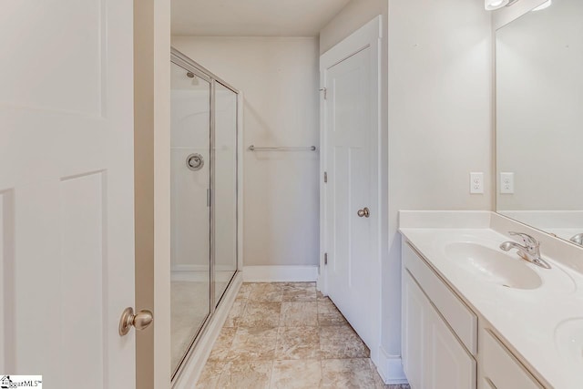 bathroom with vanity and a shower with door