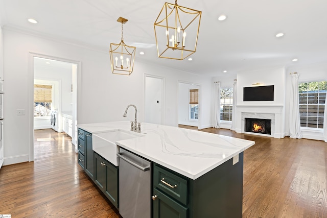 kitchen with dishwasher, pendant lighting, sink, light stone countertops, and an island with sink