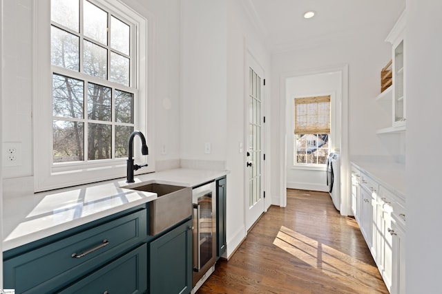 kitchen featuring a healthy amount of sunlight, sink, and washer / dryer