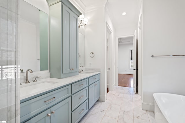 bathroom featuring a tub to relax in, vanity, and crown molding