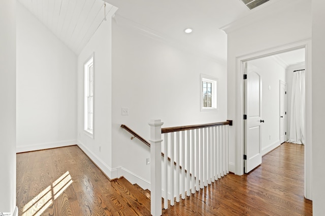 corridor featuring ornamental molding and wood-type flooring