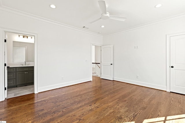 unfurnished bedroom featuring ensuite bathroom, ceiling fan, sink, ornamental molding, and dark hardwood / wood-style flooring