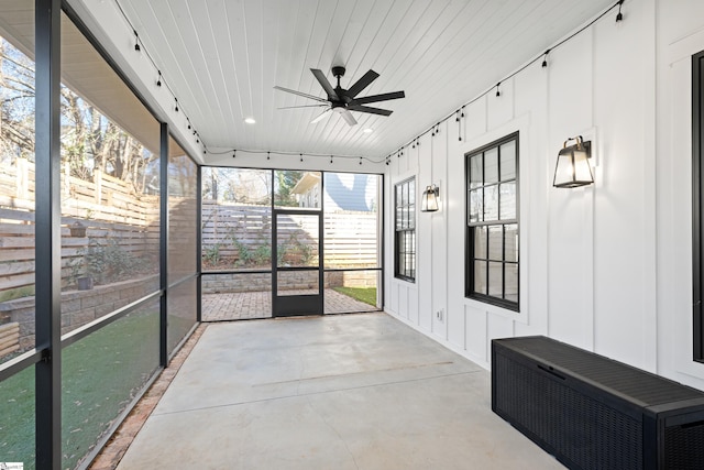 unfurnished sunroom with ceiling fan, wooden ceiling, and a wall mounted AC