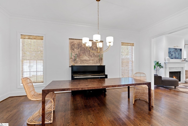 dining area featuring dark hardwood / wood-style flooring, ornamental molding, and a notable chandelier