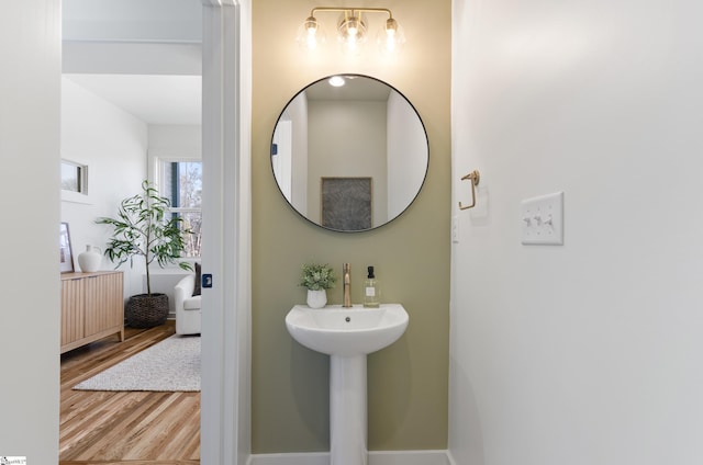 bathroom with radiator heating unit and hardwood / wood-style flooring