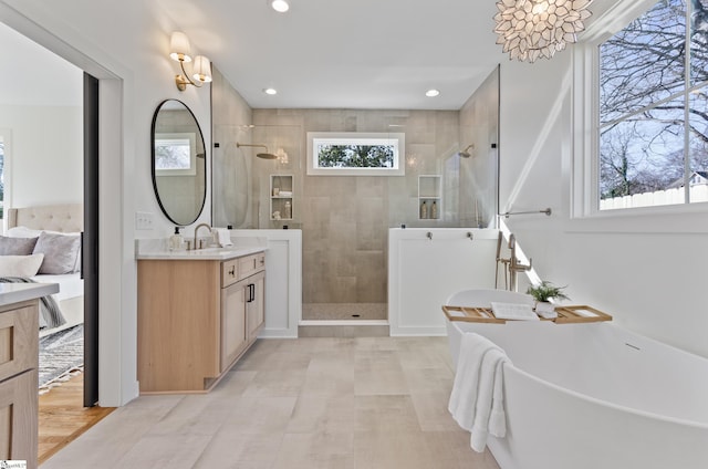 bathroom featuring vanity and plus walk in shower