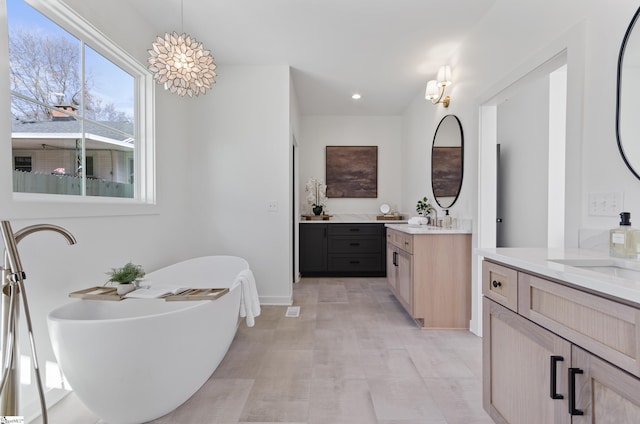 bathroom with vanity and a bathtub