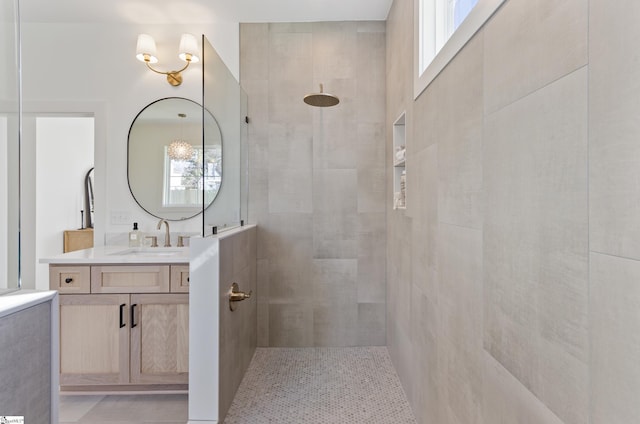 bathroom featuring vanity and a tile shower