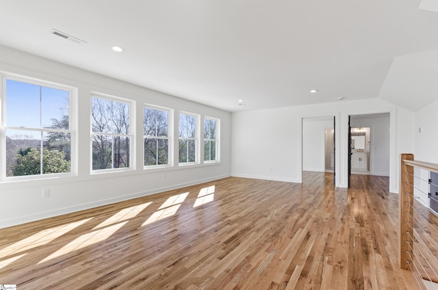 unfurnished living room with light hardwood / wood-style floors and plenty of natural light