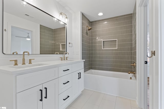bathroom featuring ceiling fan, tiled shower / bath combo, vanity, and tile patterned floors