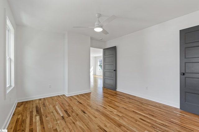 spare room featuring ceiling fan and light hardwood / wood-style floors