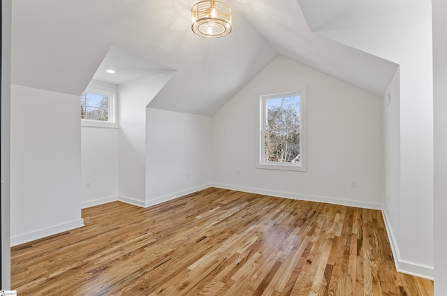bonus room featuring vaulted ceiling and light hardwood / wood-style floors