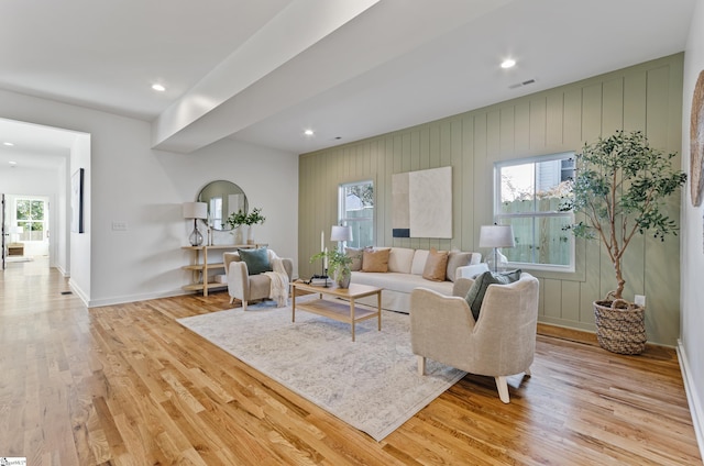 living room with a wealth of natural light and light hardwood / wood-style flooring