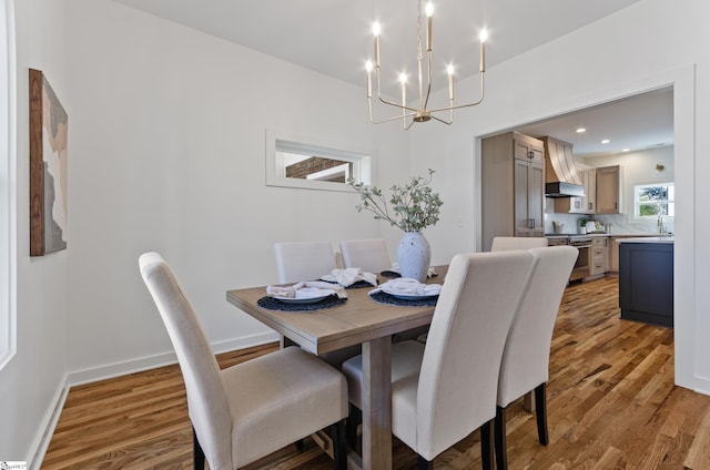 dining room featuring wood-type flooring and a notable chandelier
