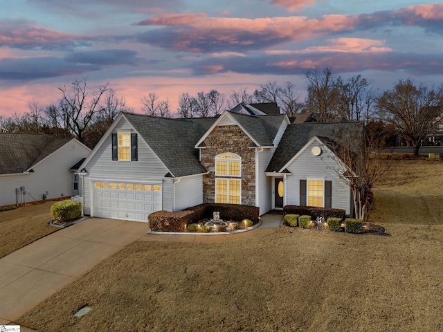 view of front of property featuring a garage and a yard