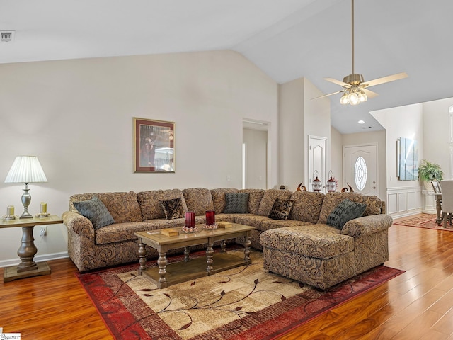 living room featuring ceiling fan, wood-type flooring, and lofted ceiling