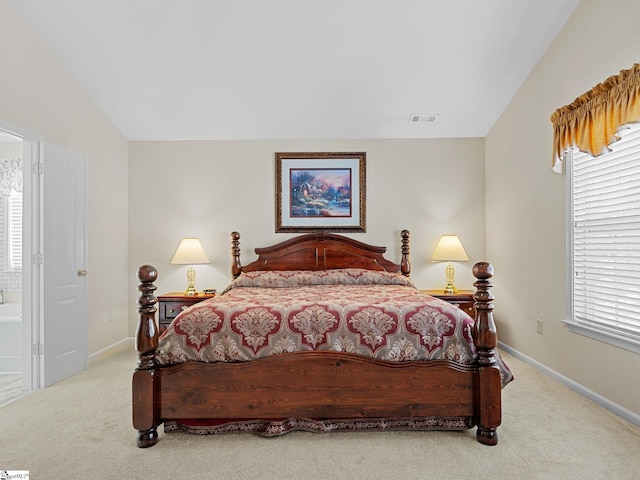 carpeted bedroom featuring vaulted ceiling and multiple windows