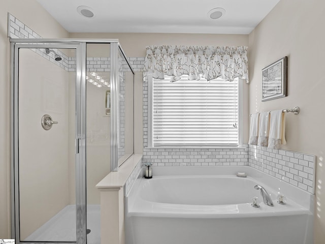 bathroom featuring shower with separate bathtub