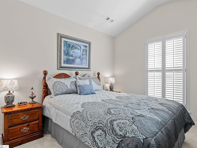 carpeted bedroom featuring lofted ceiling