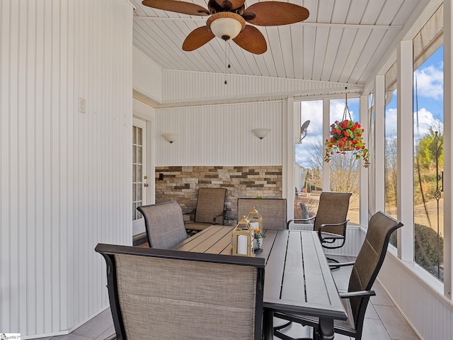 sunroom with ceiling fan, a healthy amount of sunlight, and vaulted ceiling