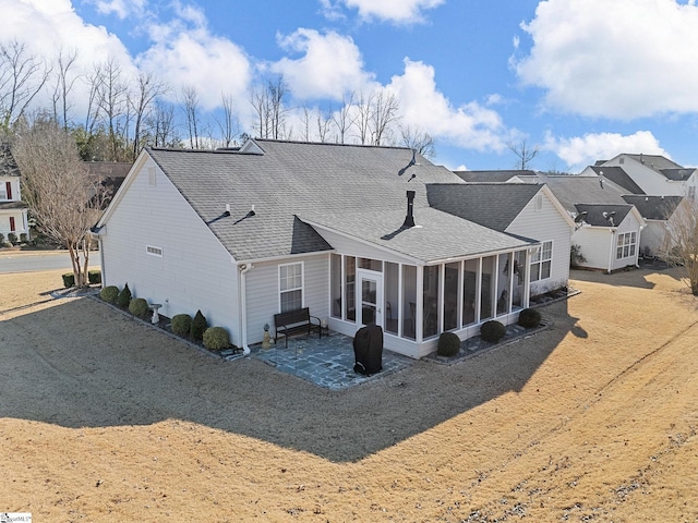 back of house with a patio area and a sunroom
