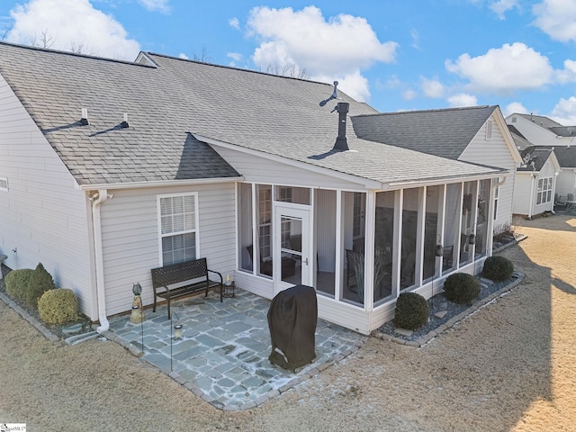 back of house with a patio area and a sunroom