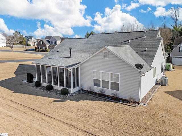 back of property featuring central AC unit and a sunroom