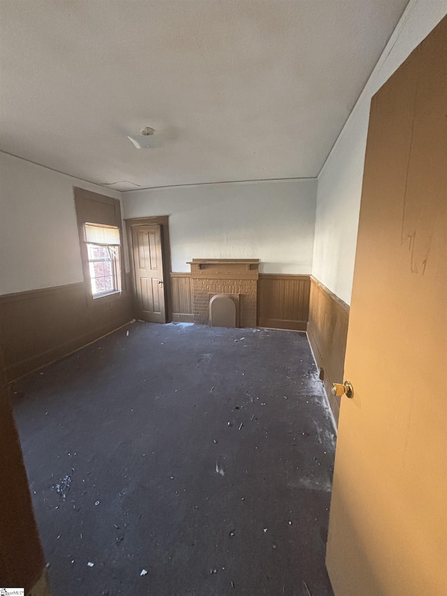 unfurnished room featuring wooden walls