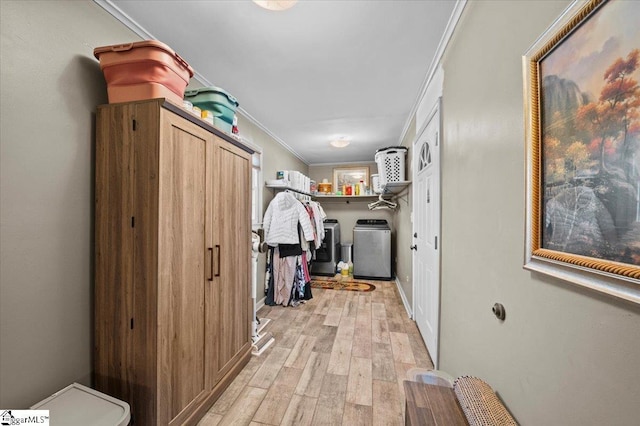 interior space with washing machine and dryer, crown molding, and light hardwood / wood-style floors