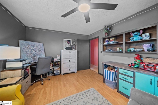 home office with light hardwood / wood-style floors, a textured ceiling, crown molding, and ceiling fan