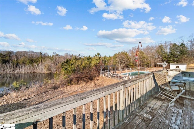 wooden terrace featuring a water view