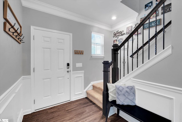 foyer with dark wood-type flooring and crown molding