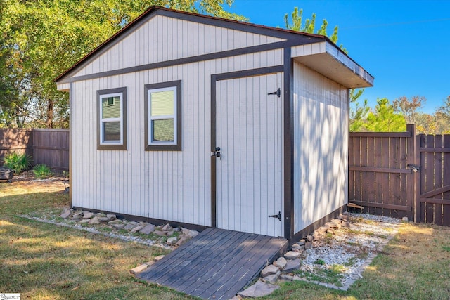 view of outbuilding with a lawn