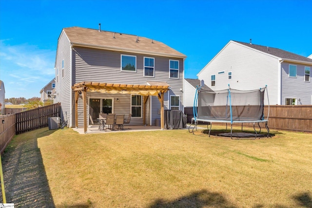 rear view of property featuring a pergola, a patio, a trampoline, central AC unit, and a yard