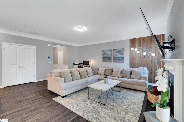 living room featuring dark hardwood / wood-style flooring and ornamental molding