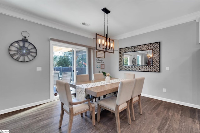 dining area featuring ornamental molding and dark hardwood / wood-style flooring