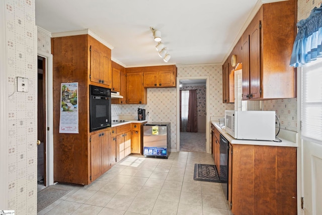 kitchen with black appliances, crown molding, and light tile patterned flooring