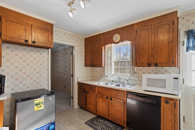 kitchen with dishwasher, light tile patterned floors, sink, ornamental molding, and stainless steel fridge