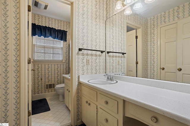 bathroom with vanity, toilet, and tile patterned flooring