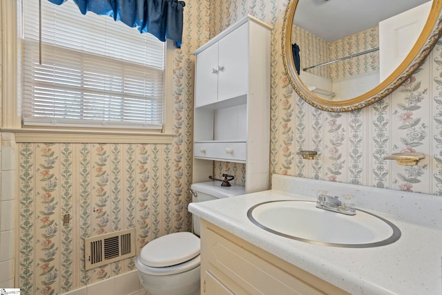 bathroom featuring toilet and vanity