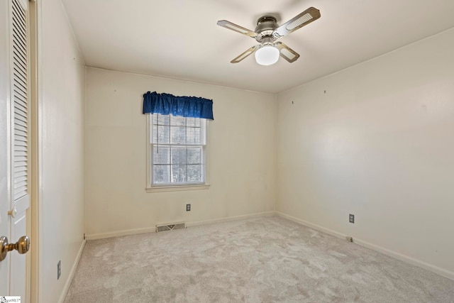 unfurnished room with ceiling fan and light colored carpet