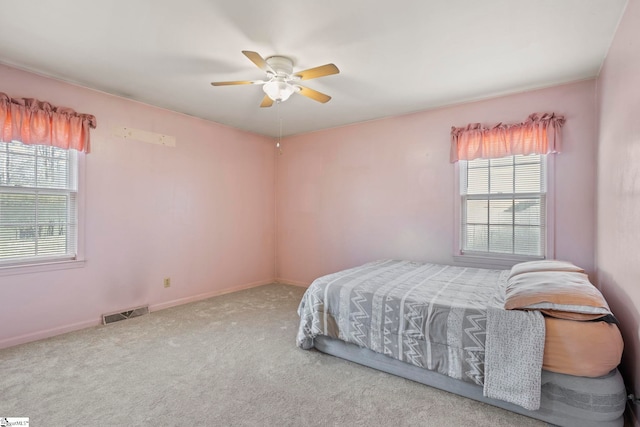 bedroom with carpet, multiple windows, and ceiling fan